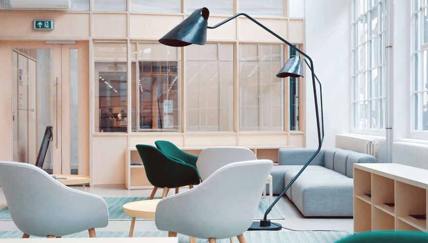 Green chairs and lamp in room - Amal Collections