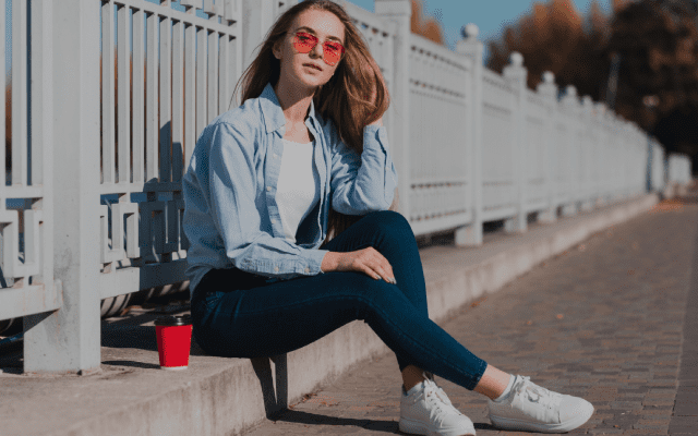 Woman sitting on a bench wearing women jeans - Amal Collections